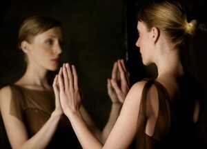 Woman Looking at Reflection --- Image by © Elisa Lazo de Valdez/Corbis