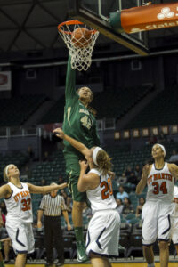 Baylor center Brittney Griner (42), center, dunks the ball over Tennessee-Martin players Megan White (32), Katie Schubert (20), and Shelby Crawford (34) during the first half of the NCAA college basketball game Saturday, Nov. 17, 2012 in Honolulu.  (AP Photo/Marco Garcia)